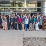 Large group of students in front of glass building