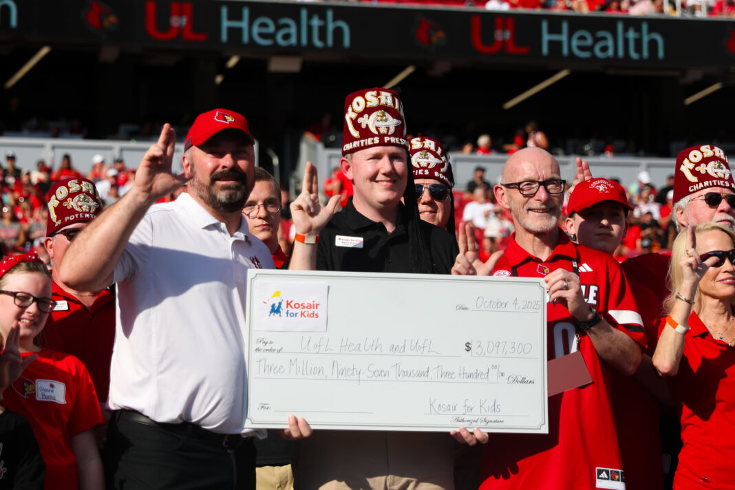 Individuals holding a large check