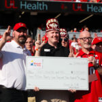 Individuals holding a large check
