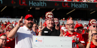 Individuals holding a large check