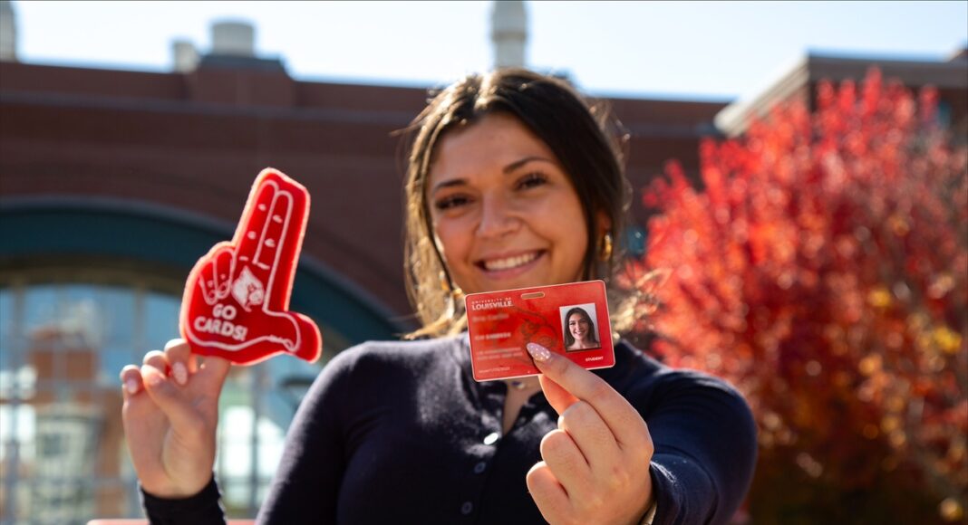 Student holds red Cardinal Card.