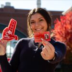 Student holds red Cardinal Card.