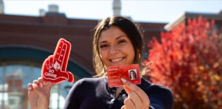 Student holds red Cardinal Card.
