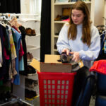 A woman puts a shoe in a box