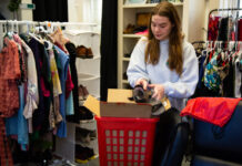 A woman puts a shoe in a box