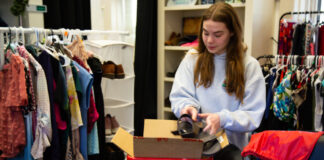 UofL Free Store grows to help more students and cut waste A woman puts a shoe in a box
