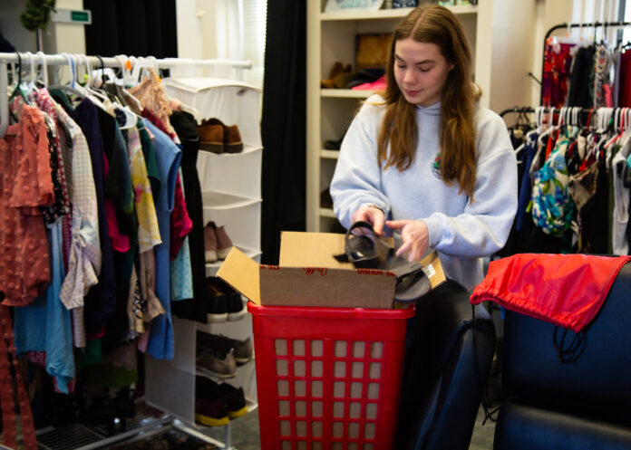 Free Store A woman puts a shoe in a box