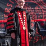 Gerry Bradley wears robe and presidential medallion