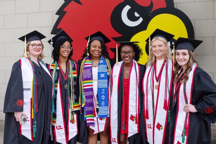 UofL graduates in commencement regalia.