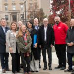 Group of people with blue canister.