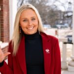 UofL student body president shares key plans Woman in red jacket raises the 'L' sign