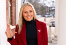 UofL student body president shares key plans Woman in red jacket raises the 'L' sign