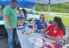 UofL graduate brings passion to promoting health in rural Kentucky communities Women sitting a table talking with a man.