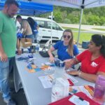 UofL graduate brings passion to promoting health in rural Kentucky communities Women sitting a table talking with a man.