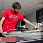 Man at worktable with metal parts
