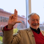 Larry Sloan holding an "L's"up