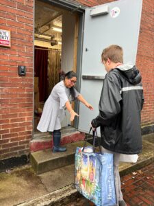 UofL student helps deliver food to the La Casita Center.