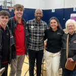 Group of people with non-perishable food items.