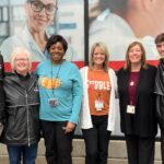 Cardinal community captures giving spirit for holidays and beyond Group of staff and students together in front of the UofL Ambulatory Care Building.