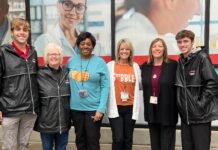 Cardinal community captures giving spirit for holidays and beyond Group of staff and students together in front of the UofL Ambulatory Care Building.