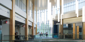 Students sitting in chairs at tables studying.