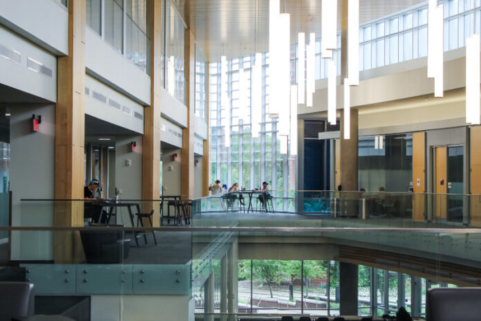 IMG_9560 Students sitting in chairs at tables studying.