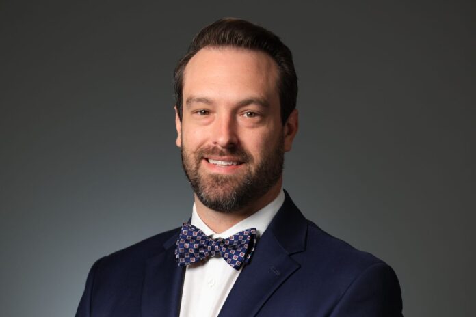 Photo headshot of Jarrod Young, executive director of Academic Simulation Center at New Health Sciences Center Building