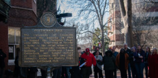 A photo of the Gottschalk Hall historical marker with people standing around it
