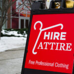 Red sign indicating location of Hire Attire.