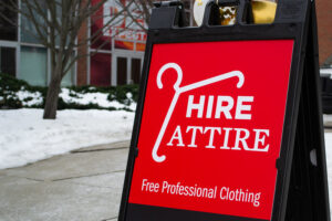 Red sign indicating location of Hire Attire.