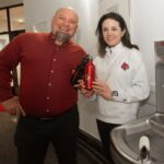 Global ranking demonstrates continuous Cardinal commitment to sustainability A man and woman holding water bottles next to a new water refill station