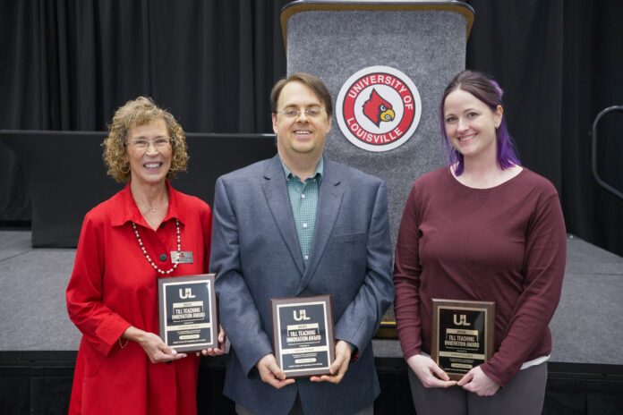 Three individuals holding award plaques