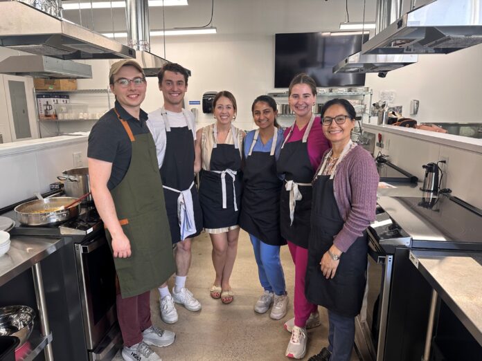 Charmi Shah '26 Culinary Medicine Six people standing in a commercial kitchen