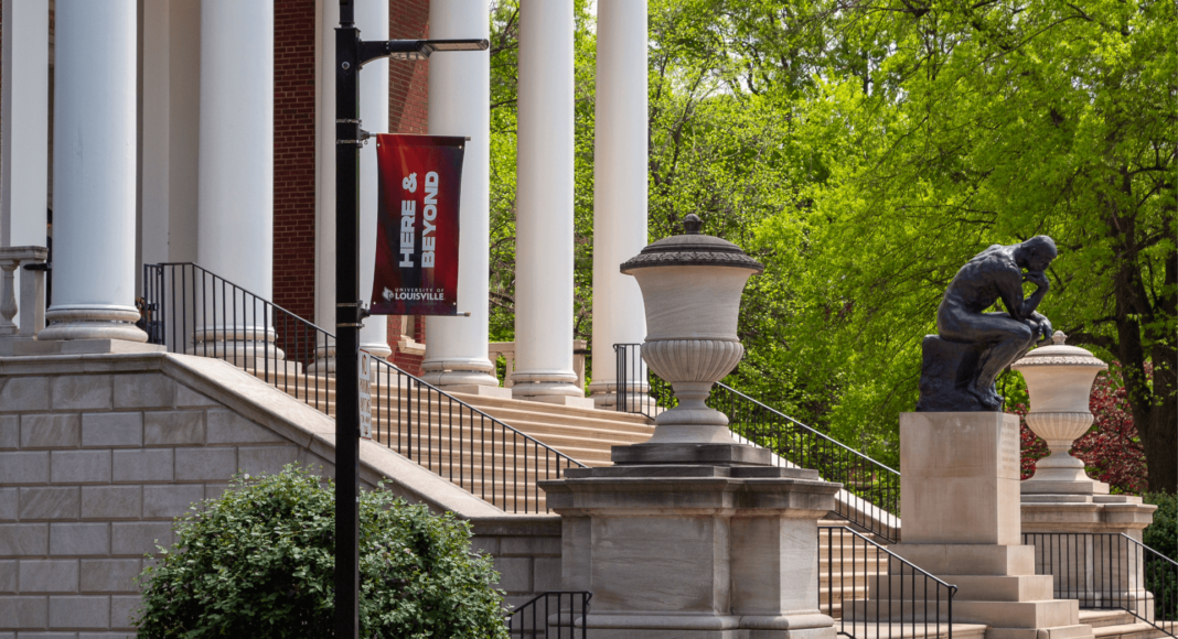 The Thinker Statue In the Springtime with a Here & Beyond Banner in the foreground