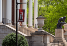The Thinker Statue In the Springtime with a Here & Beyond Banner in the foreground