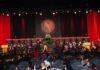 Student walks across the stage to accept a diploma