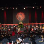 Student walks across the stage to accept a diploma