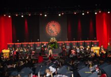 Student walks across the stage to accept a diploma