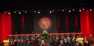 Student walks across the stage to accept a diploma