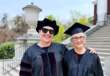 Mother and daugther, Susan and Ramie, smile in the UofL caps and gowns on campus