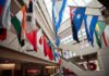 Flags from multiple countries hung around a glassed atrium