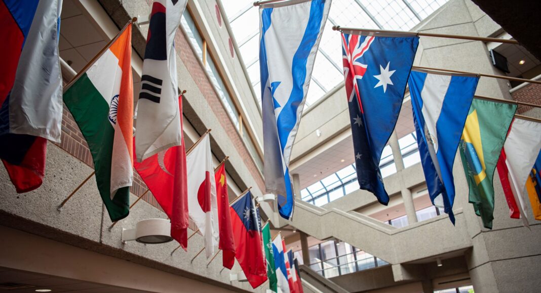 Flags from multiple countries hung around a glassed atrium