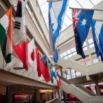 Flags from multiple countries hung around a glassed atrium