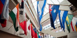 Flags from multiple countries hung around a glassed atrium