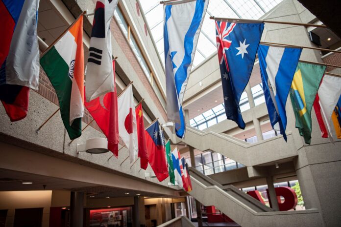 Flags from multiple countries hung around a glassed atrium