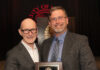 University of Louisville President Gerry Bradley (left) presents Aaron Calhoun with the 2026 UofL Trustees Award.