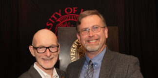 University of Louisville President Gerry Bradley (left) presents Aaron Calhoun with the 2026 UofL Trustees Award.
