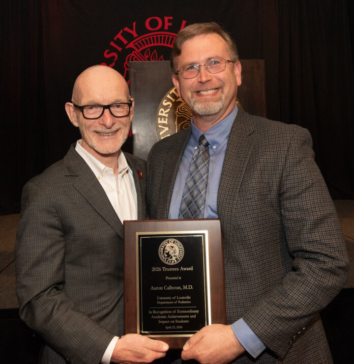 University of Louisville President Gerry Bradley (left) presents Aaron Calhoun with the 2026 UofL Trustees Award.