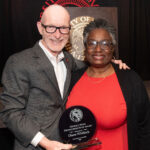 UofL President Gerry Bradley presents Diane Whitlock with the 2026 George Howe Distinguished Staff Award at the 2026 President's Excellence Awards Dinner.