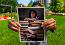 A student holds a copy of UofL Magazine